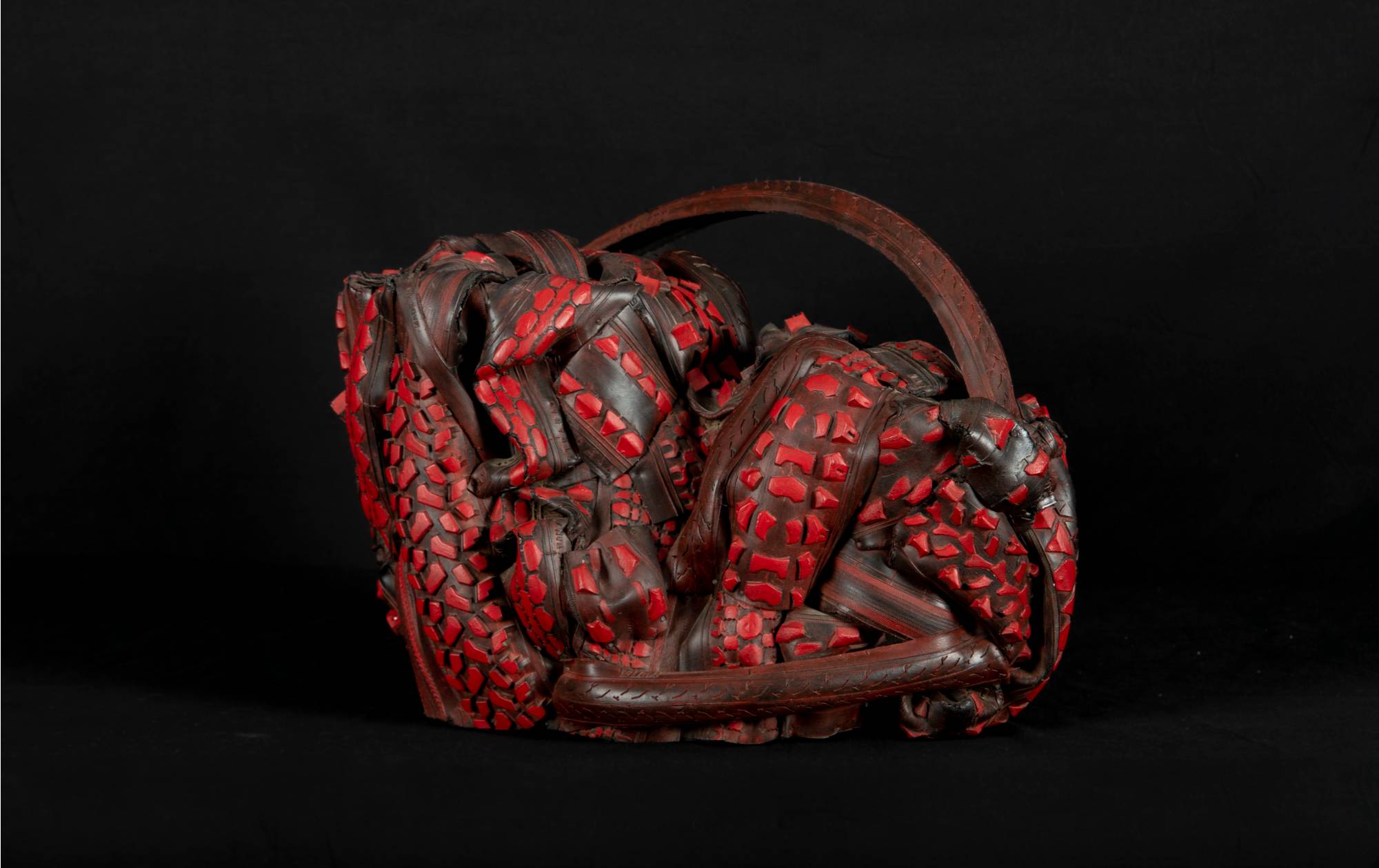 Image of a red sculpture made of tire rubber.